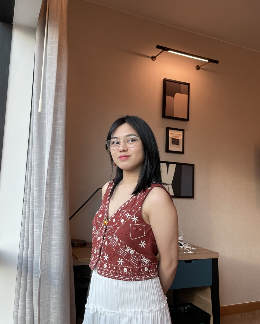 Portrait of Angel Cea standing by a window in a softly lit room